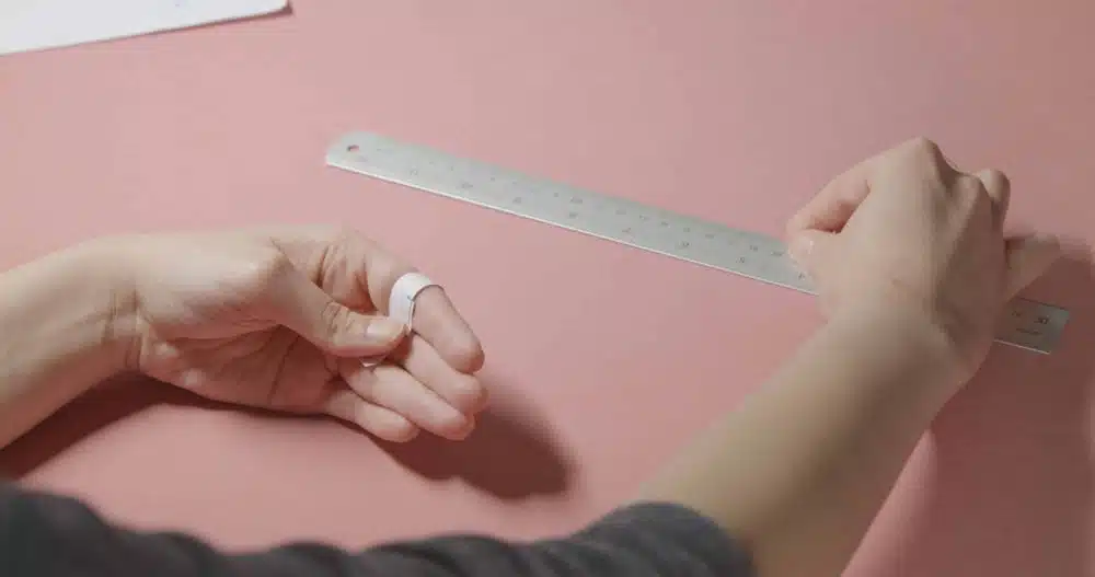 girl doing measurement for ring size