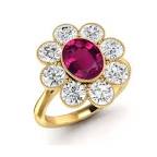 yellow gold features a halo of eight natural white diamonds surrounding an oval ruby
