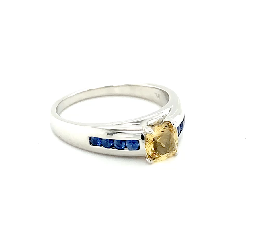 Custom Made Engagement Ring. White gold with in bezel sapphire gemstone with a yellow diamond in the centre