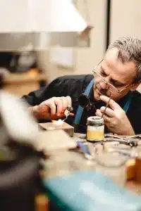 Jeweler working with tools and materials. Here to help with your consultation.